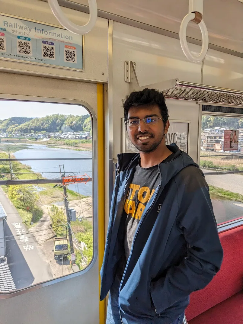 Bhishma Raj standing inside a train in Japan