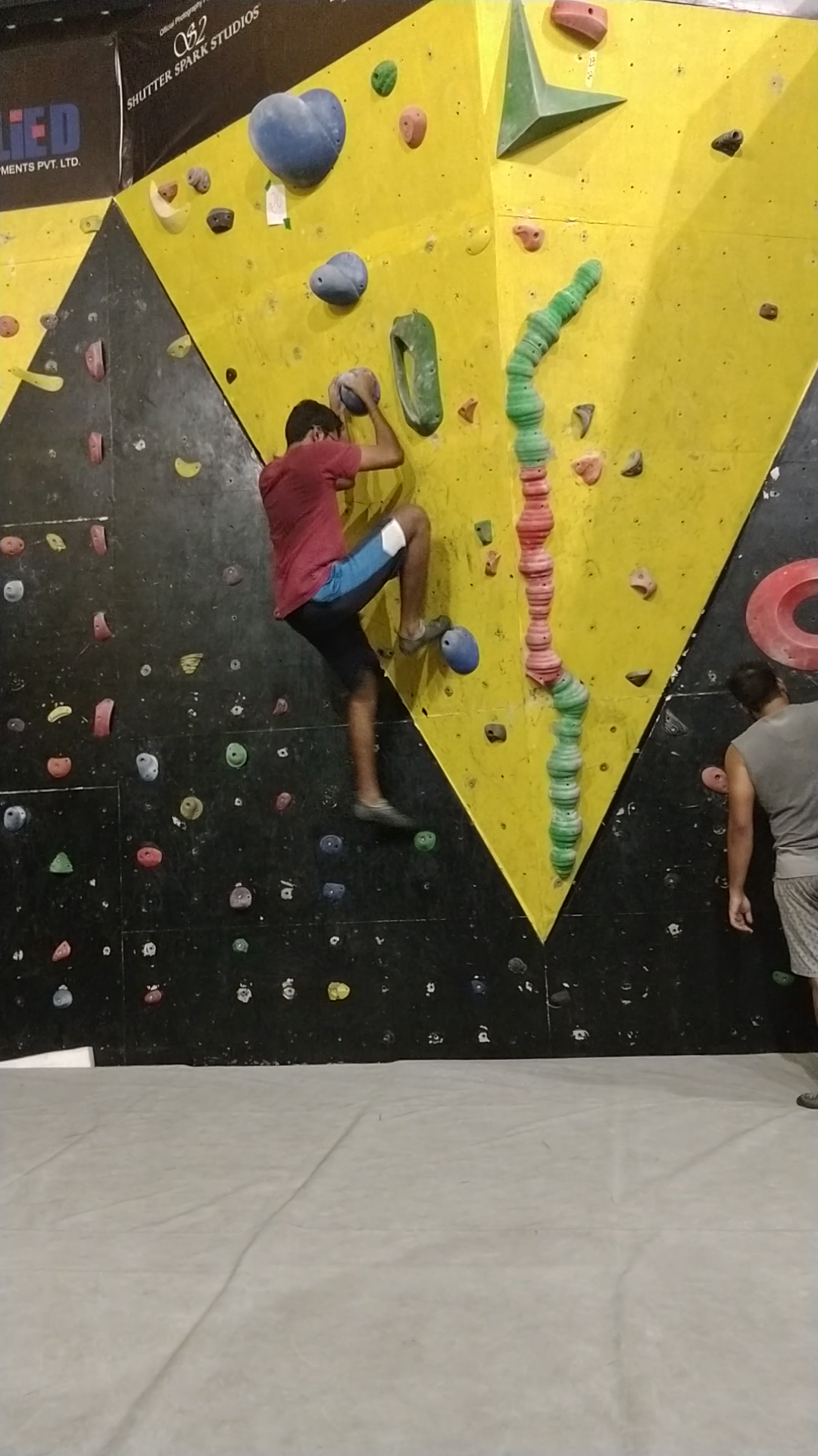 Bhishma beginning an indoor climbing route