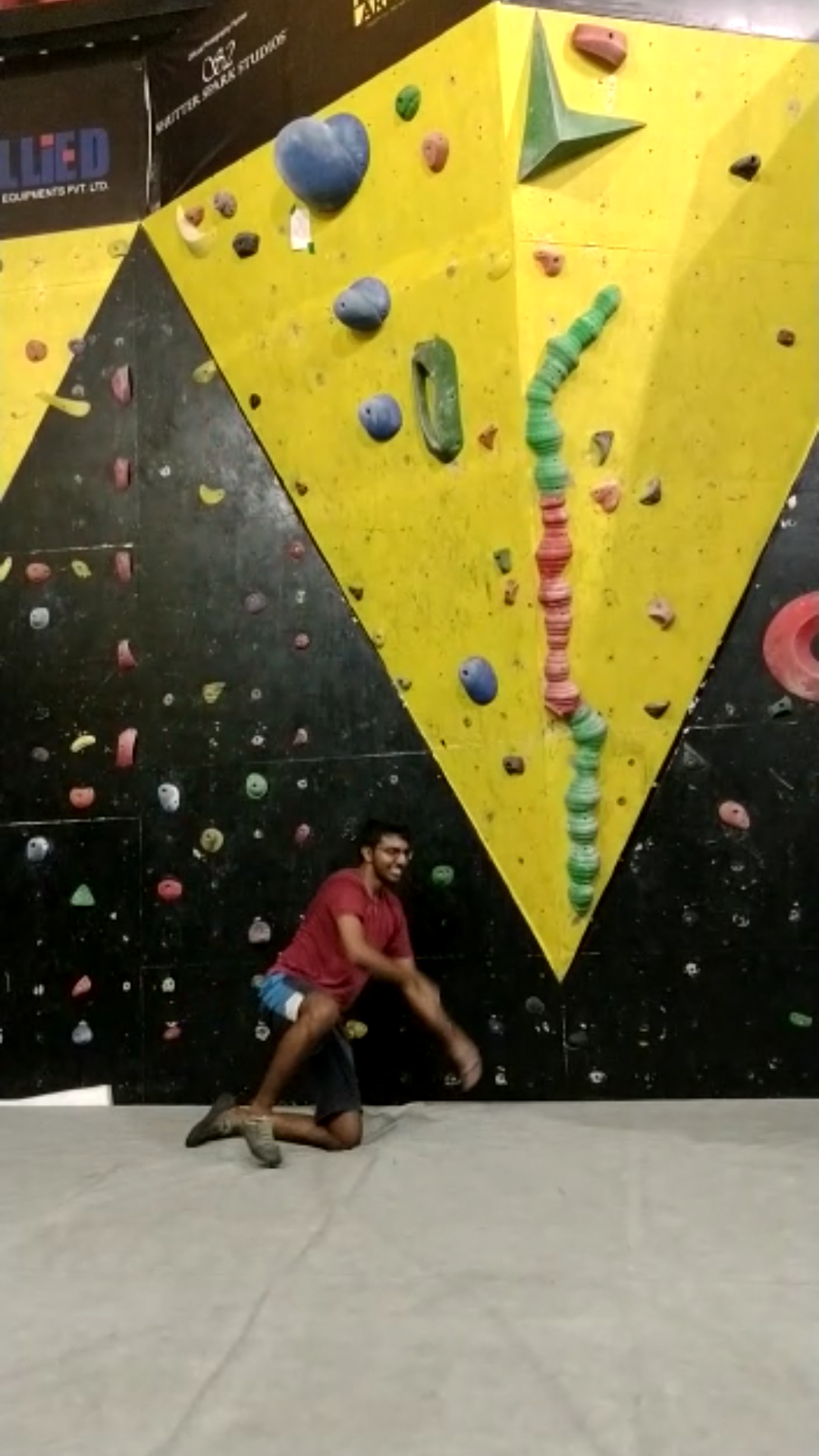 Bhishma completing an indoor climbing route